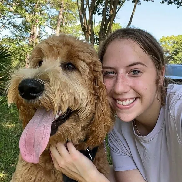 Amber Zug, owner of Woodlands Pet Retreat, with a goldendoodle