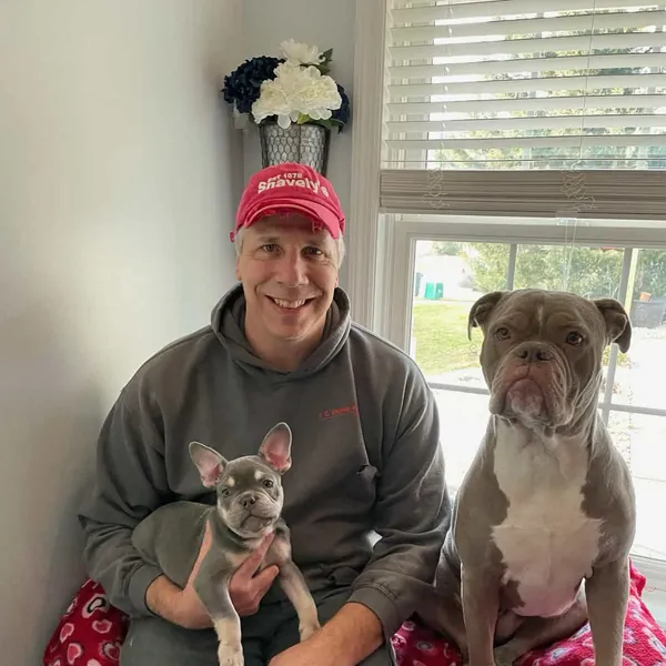Jon, partner at Woodlands Pet Retreat, with two bulldogs